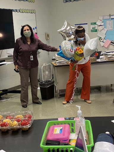 Mrs. Bartney happily accepts the title of Millbrook’s 2021 Teacher of the Year. Principal Mrs. Dana King awards Mrs. Bartney with balloons, flowers and special tiara for winning the title of Teacher of the Year. 