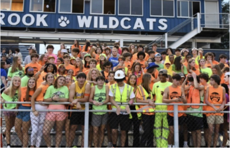 Gearing up for the game, Millbrook Maniacs lead the student section for a neon out! Themes attract more fans and encourage school spirit for the Wildcats!
