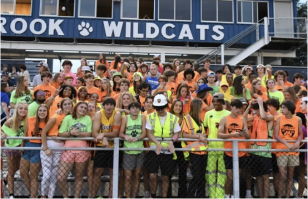 Gearing+up+for+the+game%2C+Millbrook+Maniacs+lead+the+student+section+for+a+neon+out%21+Themes+attract+more+fans+and+encourage+school+spirit+for+the+Wildcats%21
