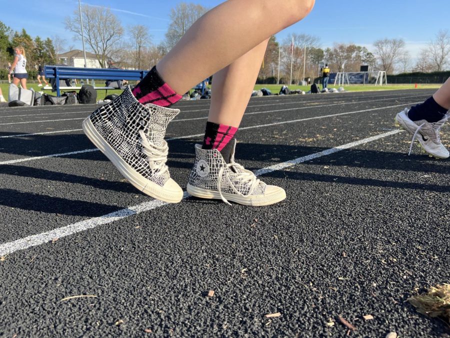 Sporting her Converse Chuck Taylors, junior Sheridan Ely walks to grab her water bottle before her lacrosse game. When choosing between Converse and Blazers, it is all about personal styles and what they are used for.