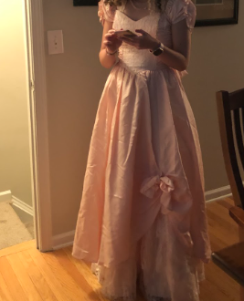 Junior Tessa Leung tried on her pink prom dress for the first time. Tessa is excited to wear this dress to prom.
