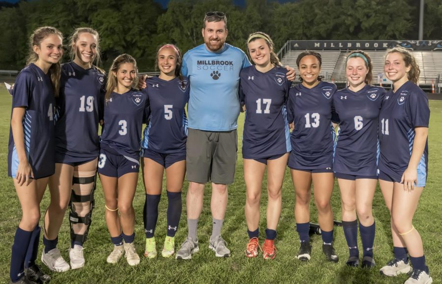 Coach+Scanlon+with+the+2021-2022+womens+soccer+seniors.+%0AMoon+and+Skye+Photography.