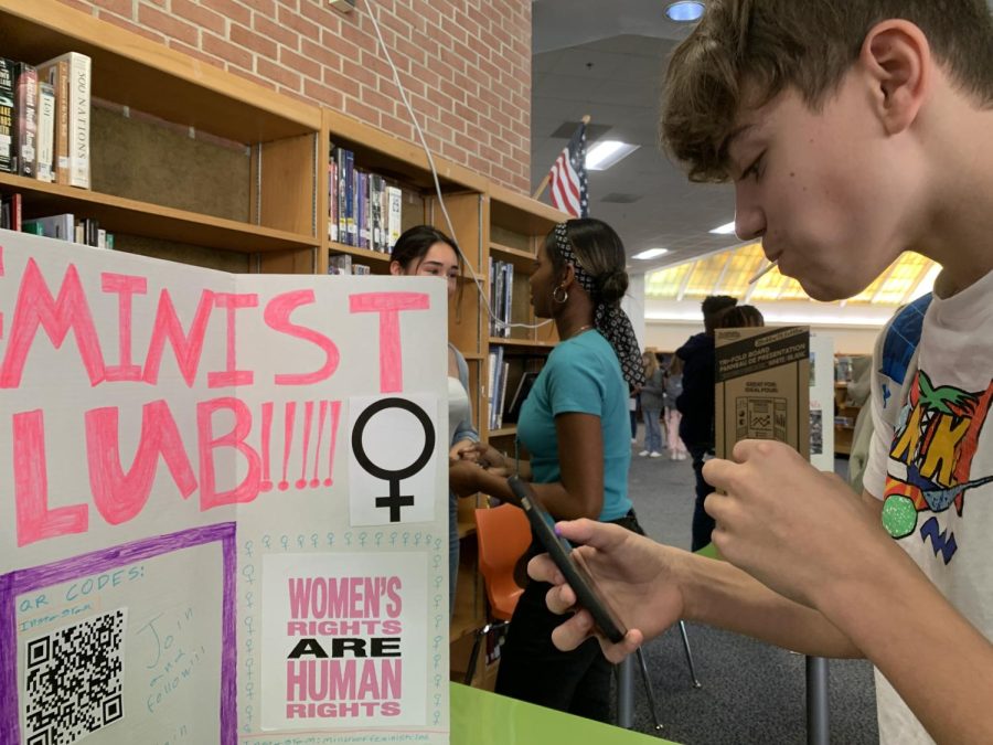 “A boy at the Activity Fair at Millbrook High School, joining the Feminist Club.”