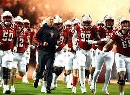 NC State head coach Dave Doeren leads the team out the tunnel at home against the Louisville Cardinals. 