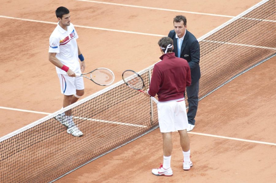 Roger Federer and Novak Djokovic at Rolland Garros in 2011. The two rivals played against eachother a whopping 50 times throughout their careers, with Federer winning 23 of them. 

