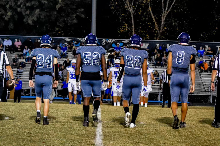 (left to right) Captains of last weeks game, Daniel Stein, Blake Mobely, Jayden Ferguson, and David Santiago walk onto the field to shake hands with the Clayton captains before the game. 
