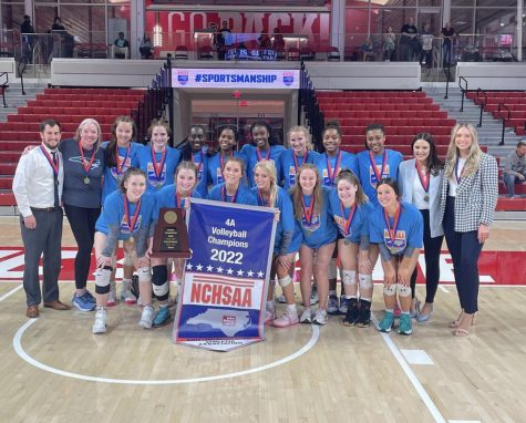 Millbrook’s varsity volleyball team celebrates their title as state champions at Reynolds Coliseum surrounded by family, friends, and fans alike.