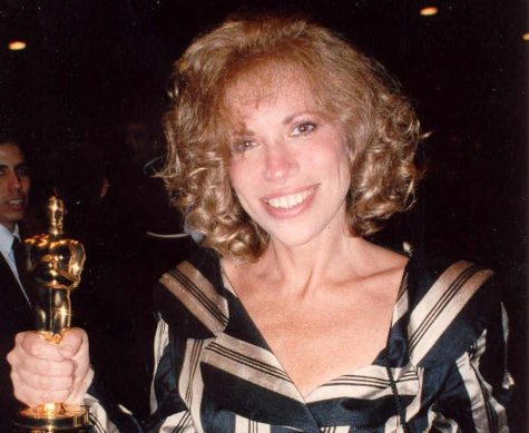 Simon receiving an academy award for her original song “Let the River Run” from the film “Working Girl.” Over her life, Simon has been nominated for close to 30 awards and has won 8. 