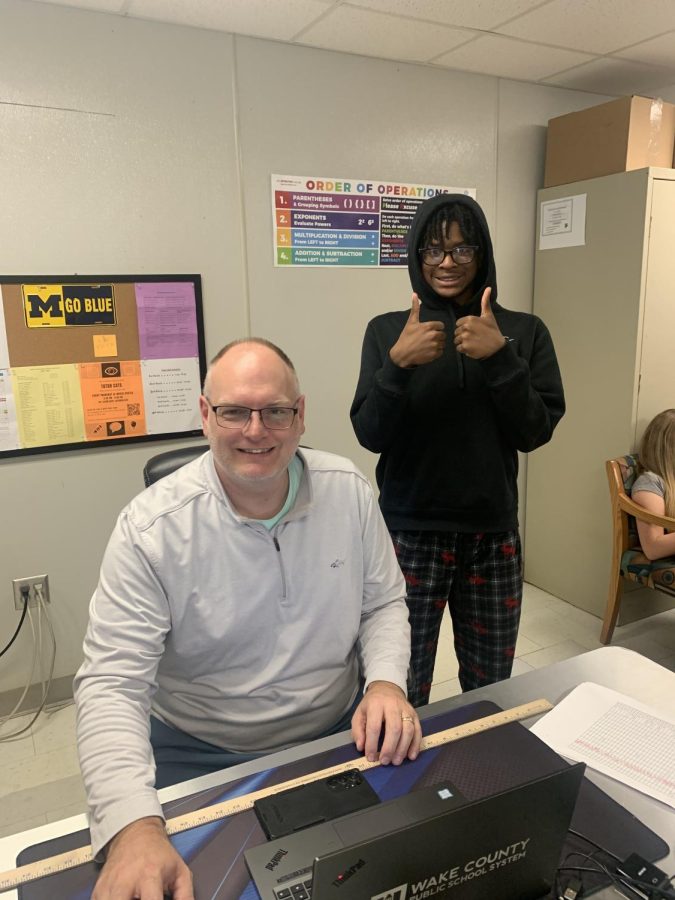  Mr. Andrus sitting at his desk joined by student Yazir James. Both with a smile on their faces!!
