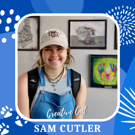 Cutler flashes a smile, showing off some of her artwork on display in the media center!
