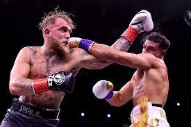 Jake Paul and Tommy Fury connecting opposite hooks on each other mid-game.
