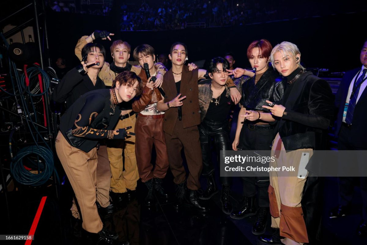  Stray Kids take a celebratory photo after their performance onstage. All eight members showed off different
poses.
