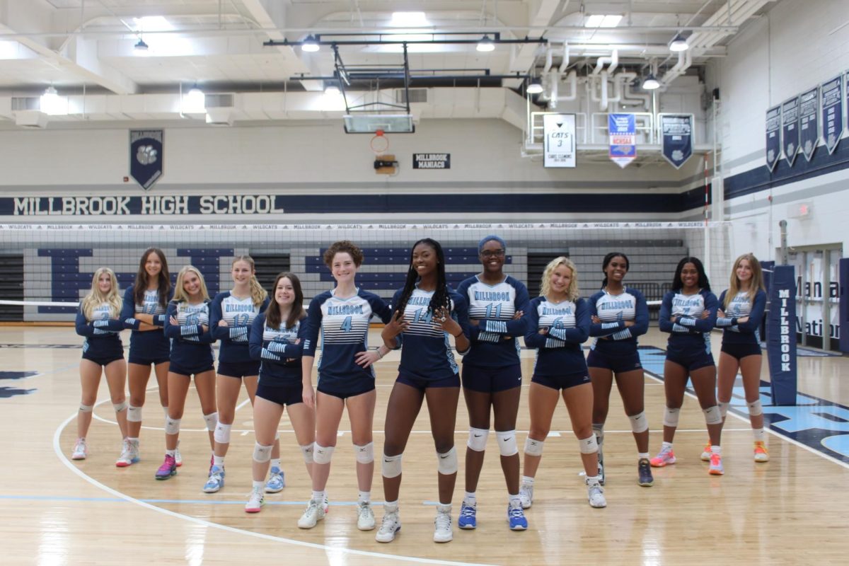 The+2023+Millbrook+volleyball+team+standing+together+as+they+prepare+for+a+good+season%21+