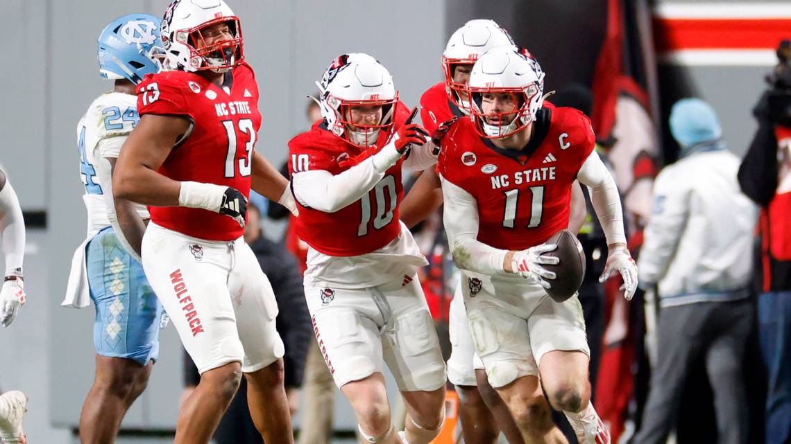 Payton Wilson (11) celebrates with defensive teammates after key takeover against UNC.