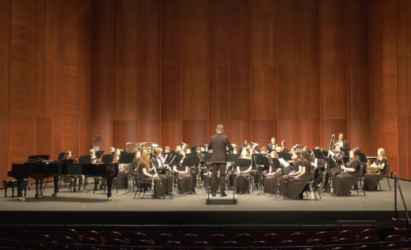 Millbrook’s wind ensemble performing on stage and last years presidents cup. The band can’t wait to perform in another big hall just like this one! 