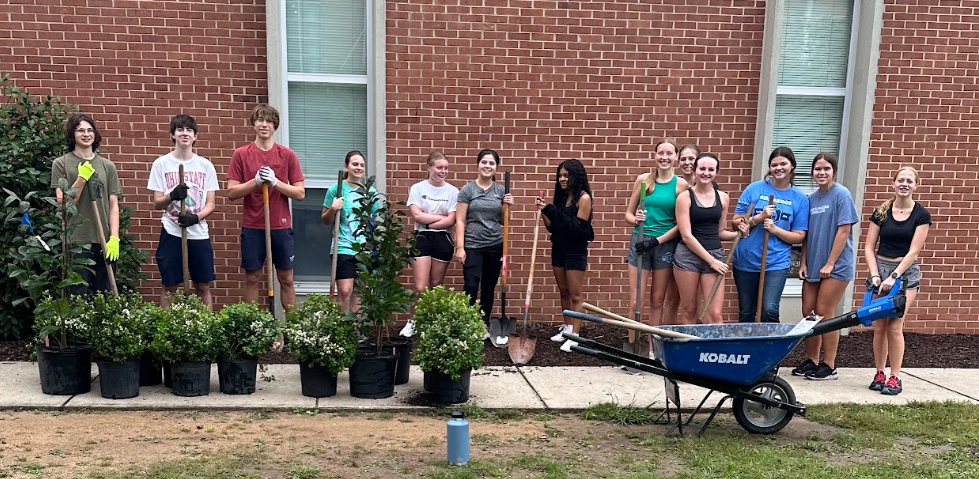 A group of volunteers help plant bushes and trees around campus for the Dana King Day of Service. The wide variety of community involvement helped not only the school to improve but the surrounding community as well. 
