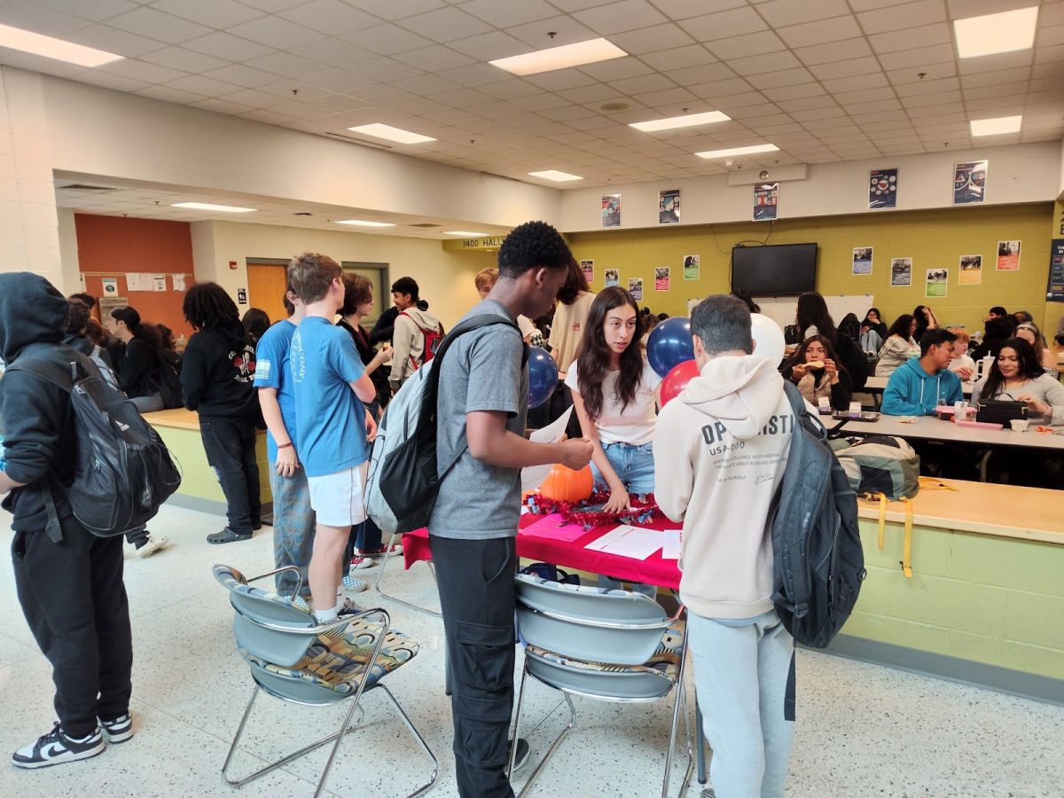 Student volunteer helps classmates register. This was during lunchtime.