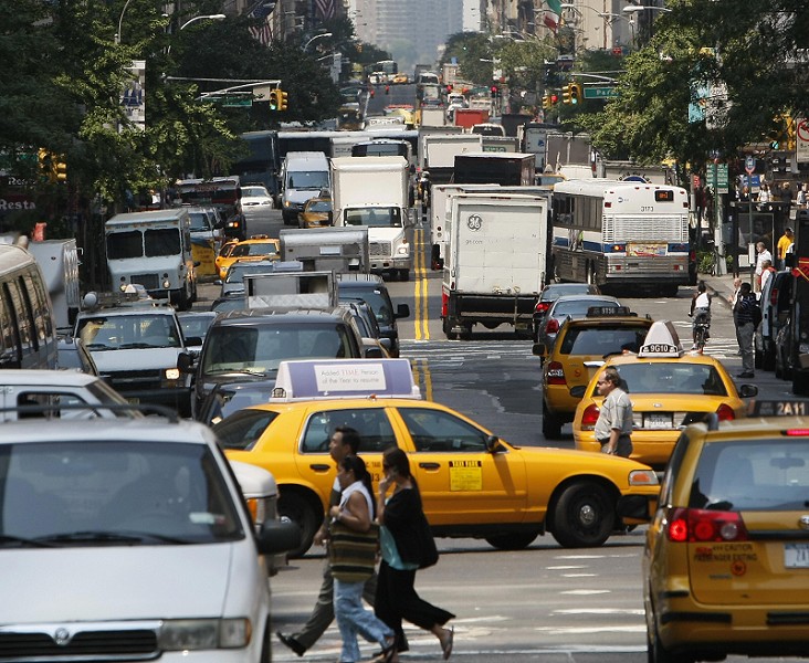 Traffic in one of NYCs busiest boroughs, Manhattan. Crowded with taxis, trucks, buses, and your average car. 