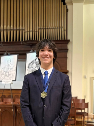 Sawyer Graham awarded with a medal at an art competition