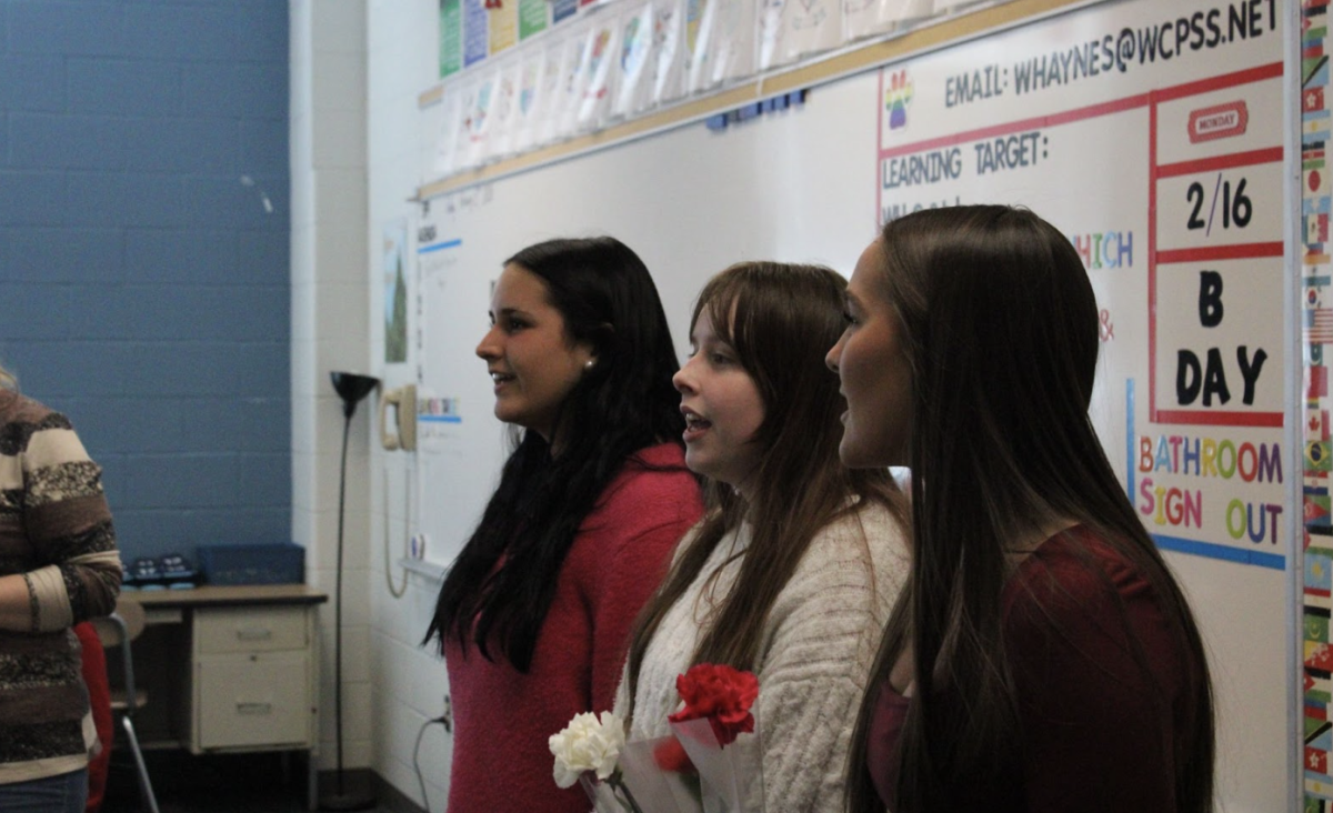 Members of Millbrooks Madrigals and Celeste choirs performed in classes to celebrate valentines day! (from left to right, Ella Jane Werner, Sadie Kelsey, Lily Ibrahim)
